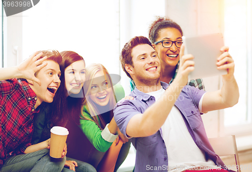 Image of students making picture with tablet pc at school