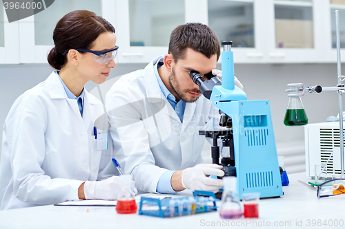 Image of young scientists making test or research in lab