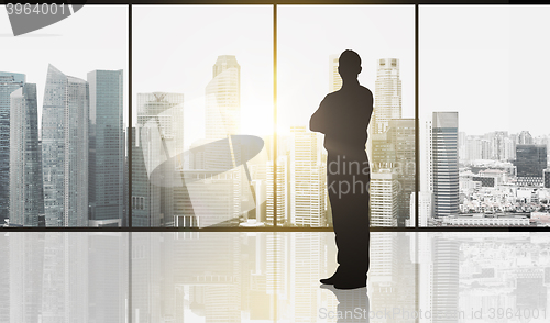 Image of silhouette of business man over office background