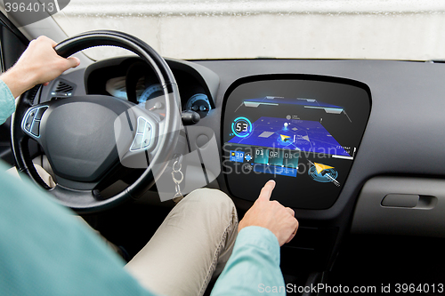 Image of close up of man driving car with gps navigator map