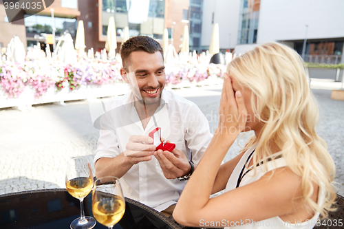 Image of man with engagement ring making proposal to woman