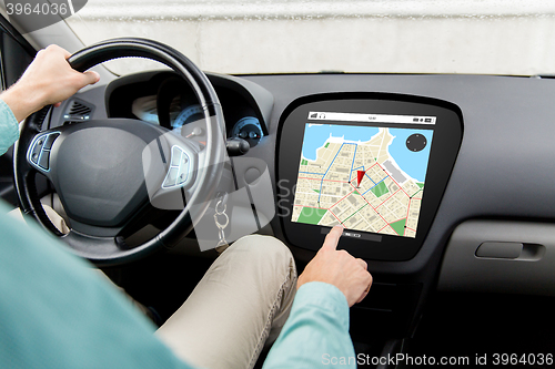 Image of close up of man driving car with gps navigator map