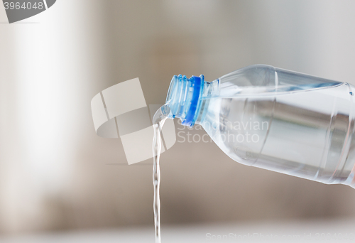 Image of close up of water pouring from plastic bottle