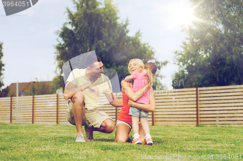 Image of happy family hugging outdoors