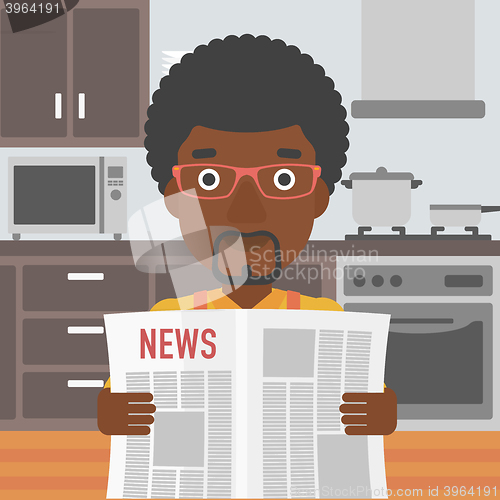 Image of Man reading newspaper.