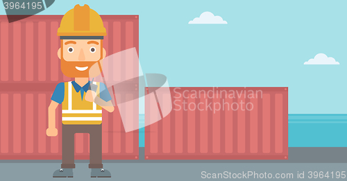 Image of Stevedore standing on cargo containers background.