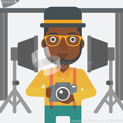 Image of Smiling photographer holding camera.