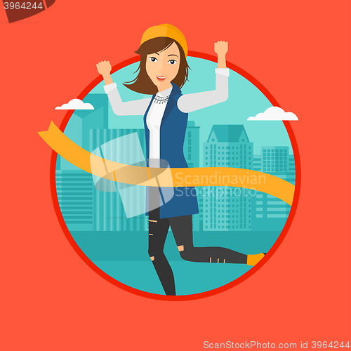 Image of Business woman crossing finish line.