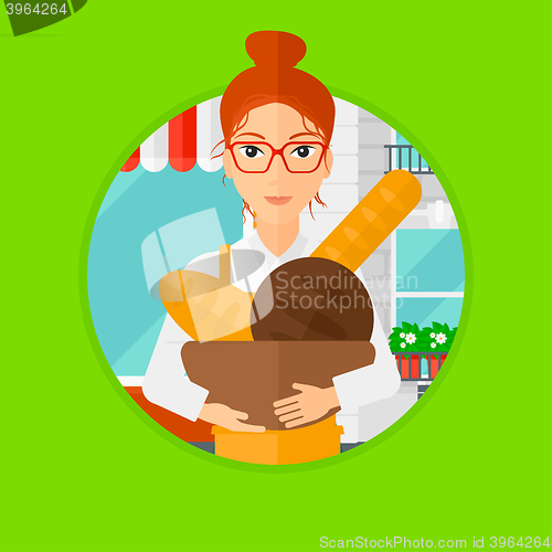 Image of Baker holding basket with bakery products.