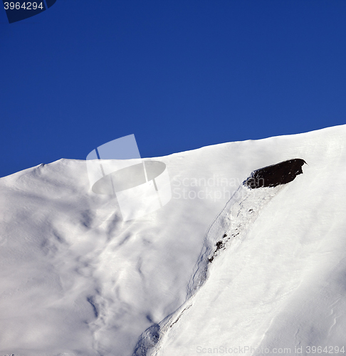 Image of Trace of avalanche on off-piste slope in sunny day