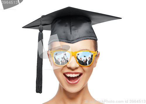 Image of happy teenage girl in shades and mortarboard hat