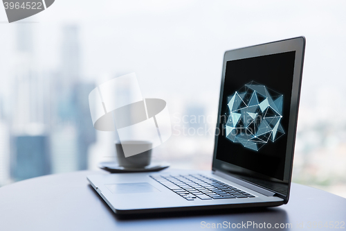 Image of close up of laptop and coffee cup on office table