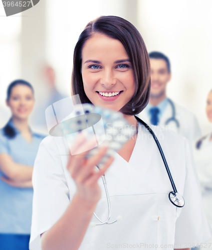 Image of doctor with blister packs of pills