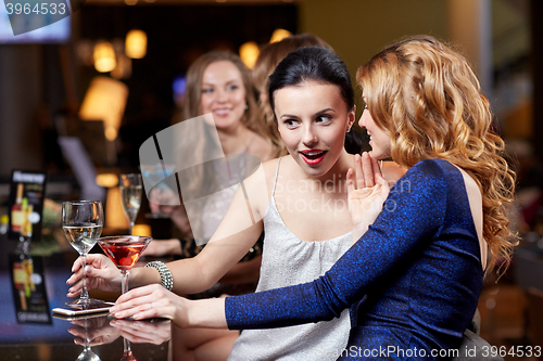 Image of happy women with drinks at night club