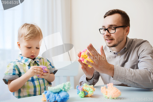 Image of father and son playing with ball clay at home