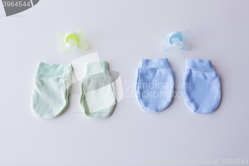 Image of close up of baby mittens and soothers for twins