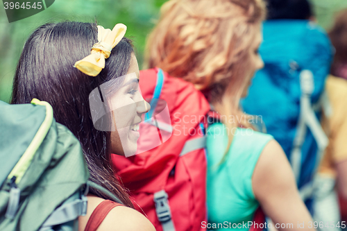 Image of group of smiling friends with backpacks hiking
