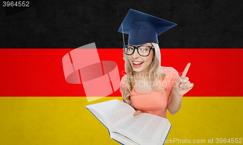 Image of student woman in mortarboard with encyclopedia