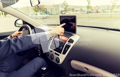 Image of close up of young man with tablet pc driving car