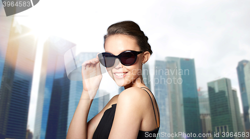 Image of beautiful young woman in elegant black sunglasses