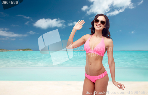 Image of happy woman in sunglasses and bikini swimsuit