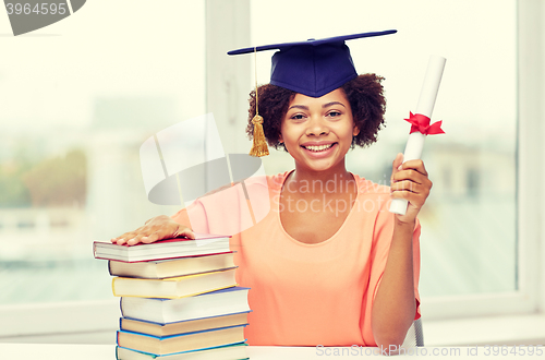 Image of happy african bachelor girl with books and diploma