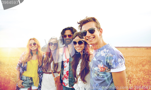 Image of smiling young hippie friends on cereal field