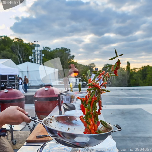 Image of chef tossing vegetables in a wok