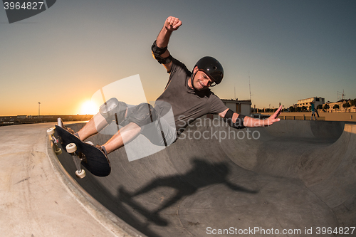 Image of Skateboarder in a concrete pool 