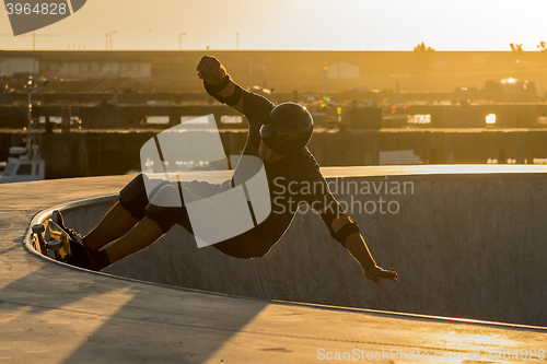 Image of Skateboarder in a concrete pool 