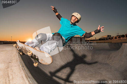 Image of Skateboarder in a concrete pool 