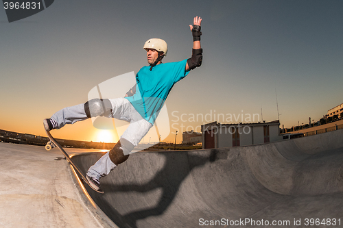 Image of Skateboarder in a concrete pool 