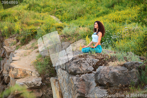 Image of Young woman is practicing yoga