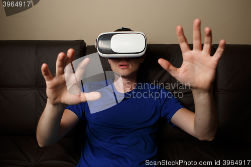 Image of Man wearing virtual reality goggles.