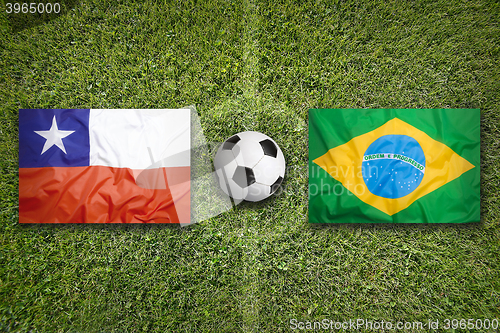 Image of Chile vs. Brazil flags on soccer field