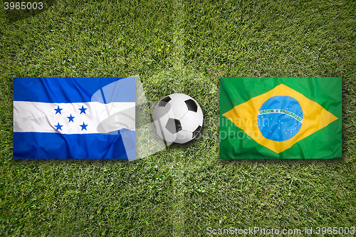 Image of Honduras vs. Brazil flags on soccer field