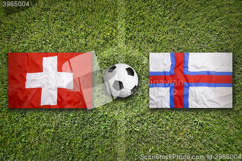 Image of Switzerland vs. Faeroe Islands flags on soccer field