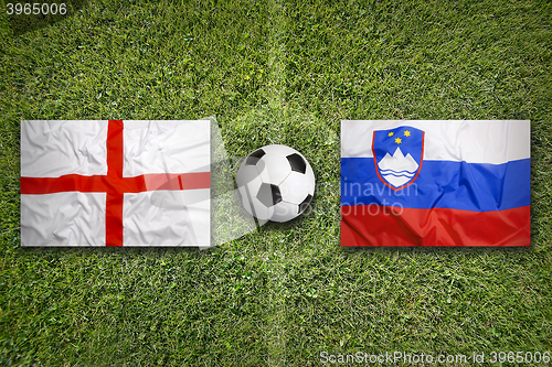 Image of England vs. Slovenia flags on soccer field