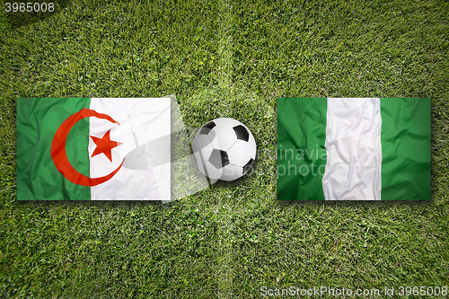 Image of Algeria vs. Nigeria flags on soccer field