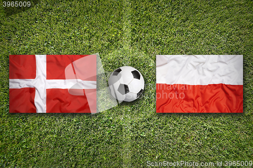 Image of Denmark vs. Poland flags on soccer field