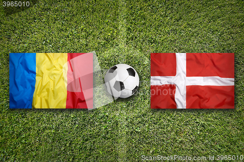 Image of Romania vs. Denmark flags on soccer field