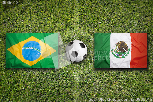 Image of Brazil vs. Mexico flags on soccer field