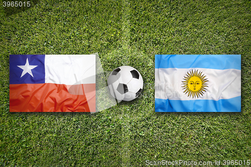 Image of Chile vs. Argentina flags on soccer field