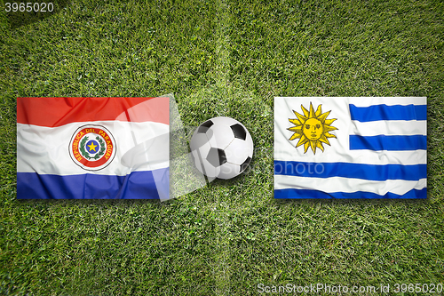 Image of Paraguay vs. Uruguay flags on soccer field