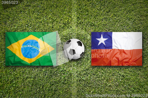 Image of Brazil vs. Chile flags on soccer field