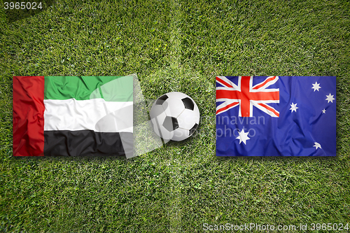 Image of United Arab Emirates vs. Australia flags on soccer field