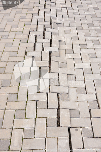 Image of A large crack in the paving tiles