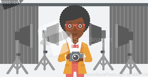 Image of Smiling photographer holding camera.