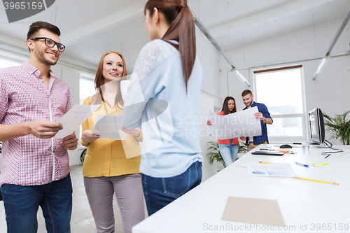 Image of creative team on coffee break talking at office