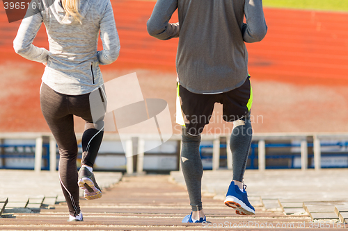 Image of close up of couple running downstairs on stadium